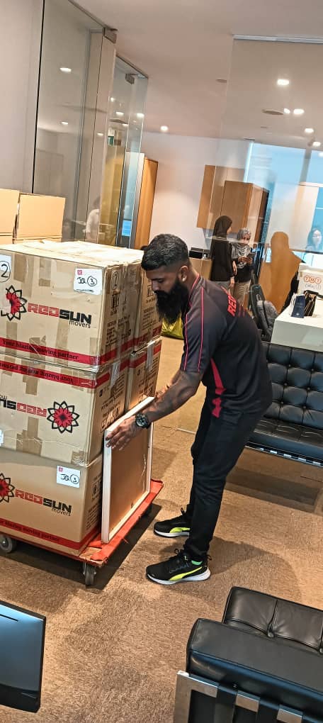 Commercial moving services in Singapore handling office boxes during relocation