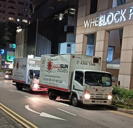 Movers Singapore transporting goods with moving trucks during a relocation service in the city