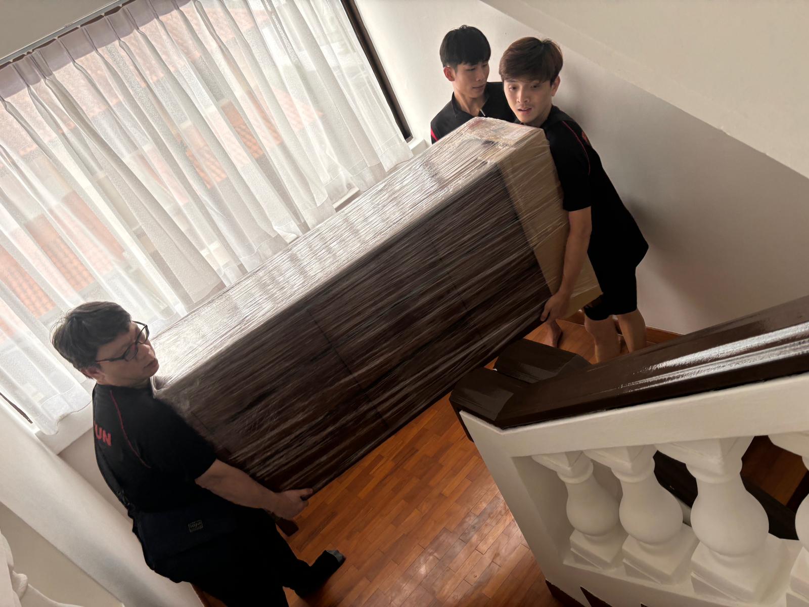 movers loading furniture for cross-border transport 